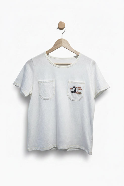 White t-shirt with a pocket and graphic on a hanger against a plain background